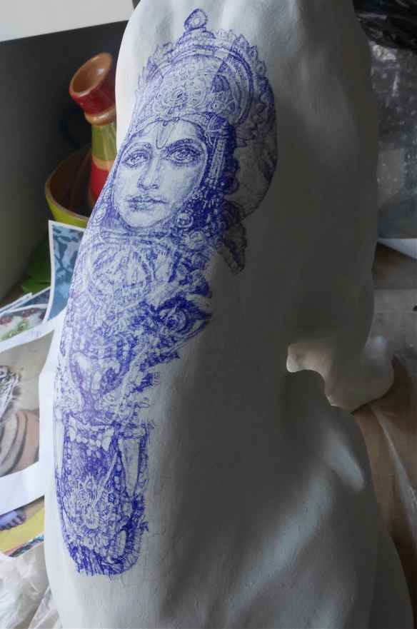 Detail of sculpture tattoo blue Biro drawing on curved back of tiger figurine