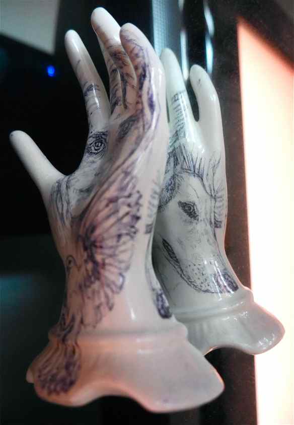 Reflection of back of china hand with drawing of Lily and dove.