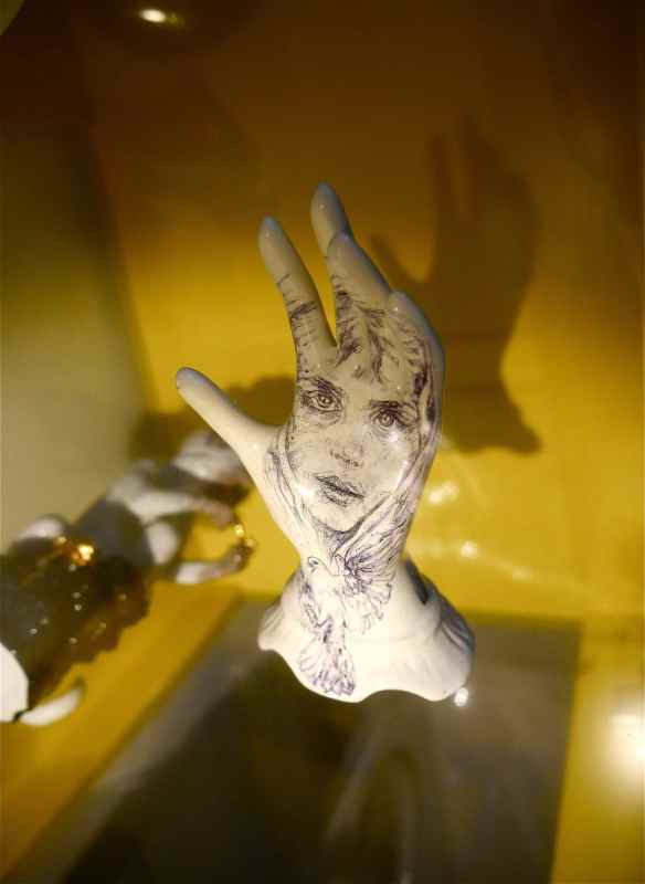Sculpture tattoo on glass shelf.